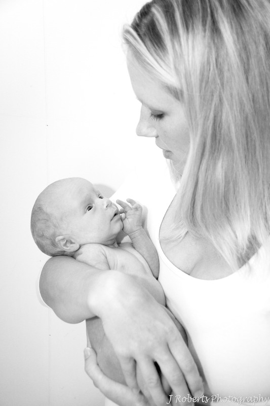 Mother cuddling a newborn baby - baby portrait photography sydney